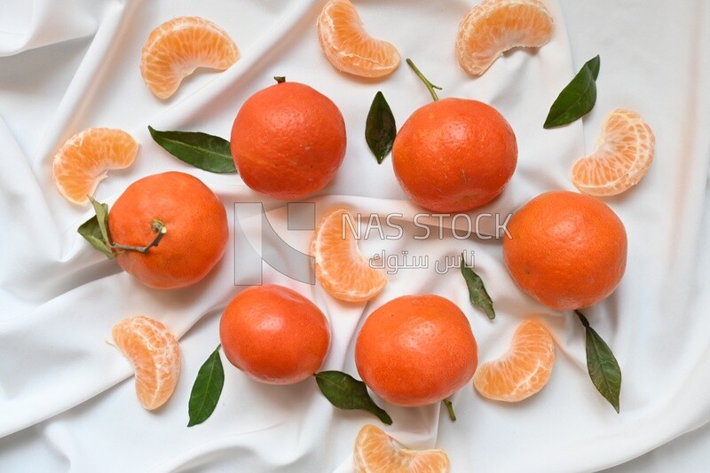 Tangerine with tangerine slices on a white background