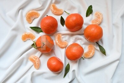 Tangerine with tangerine slices on a white background