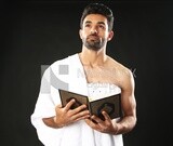 A man wearing an ihram dress prays