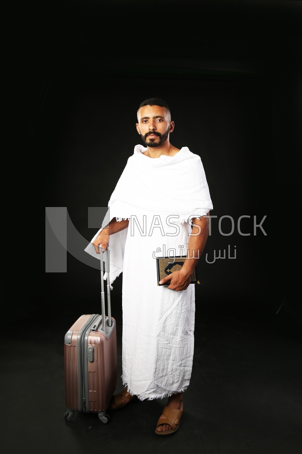 A man wearing an ihram dress prays