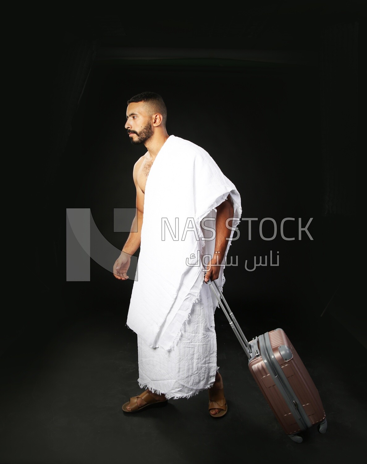 A man wearing an ihram dress with his luggage