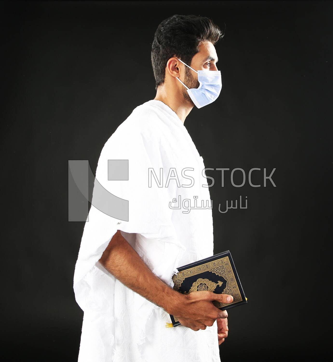 A man wearing an ihram dress prays