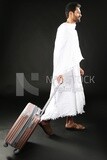 A man wearing an ihram dress with his luggage