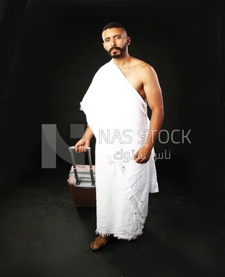 A man wearing an ihram dress with his luggage