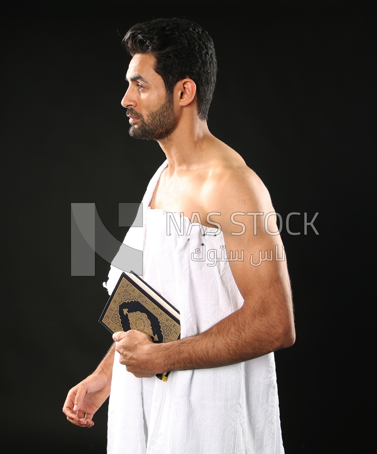 A man wearing an ihram dress prays