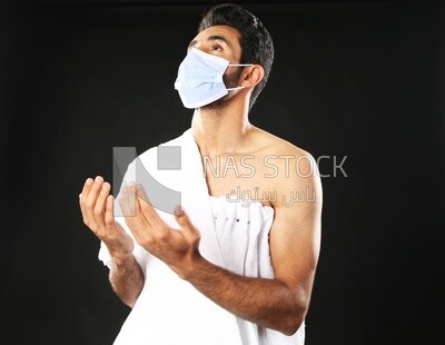 A man wearing an ihram dress with a mask