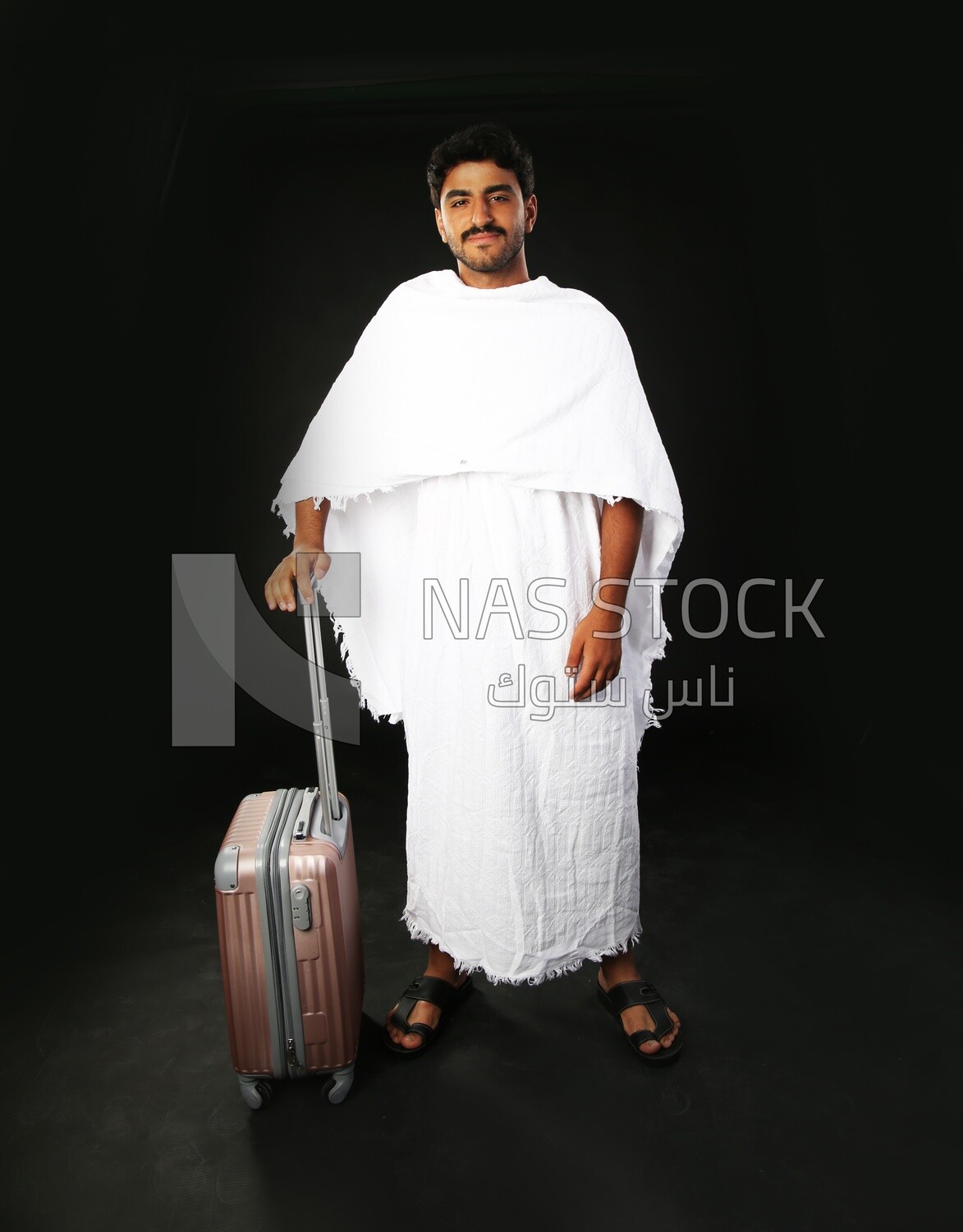 A man wearing an ihram dress with his luggage