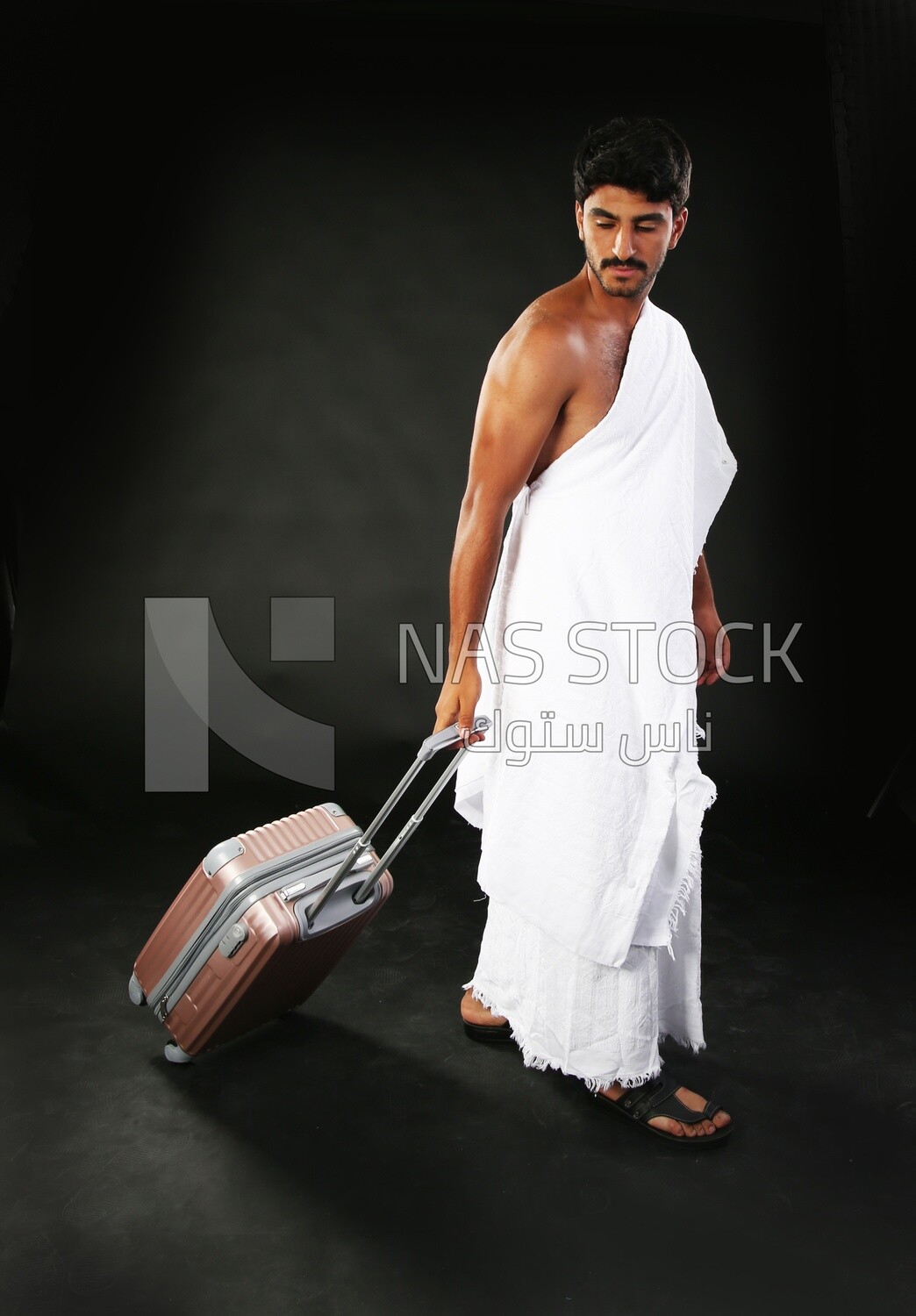 A man wearing an ihram dress with his luggage