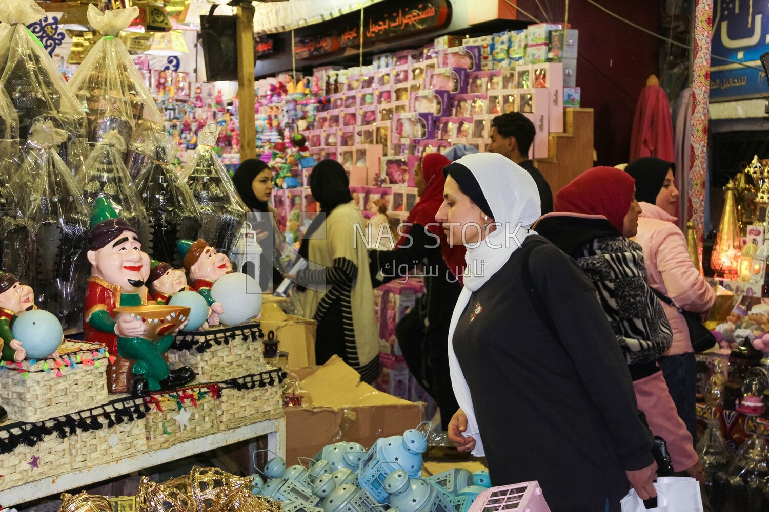 woman watching and choosing from a group of Ramadan decorations