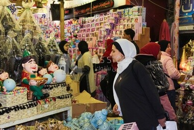 woman watching and choosing from a group of Ramadan decorations