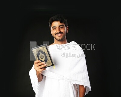A man wearing an ihram dress prays