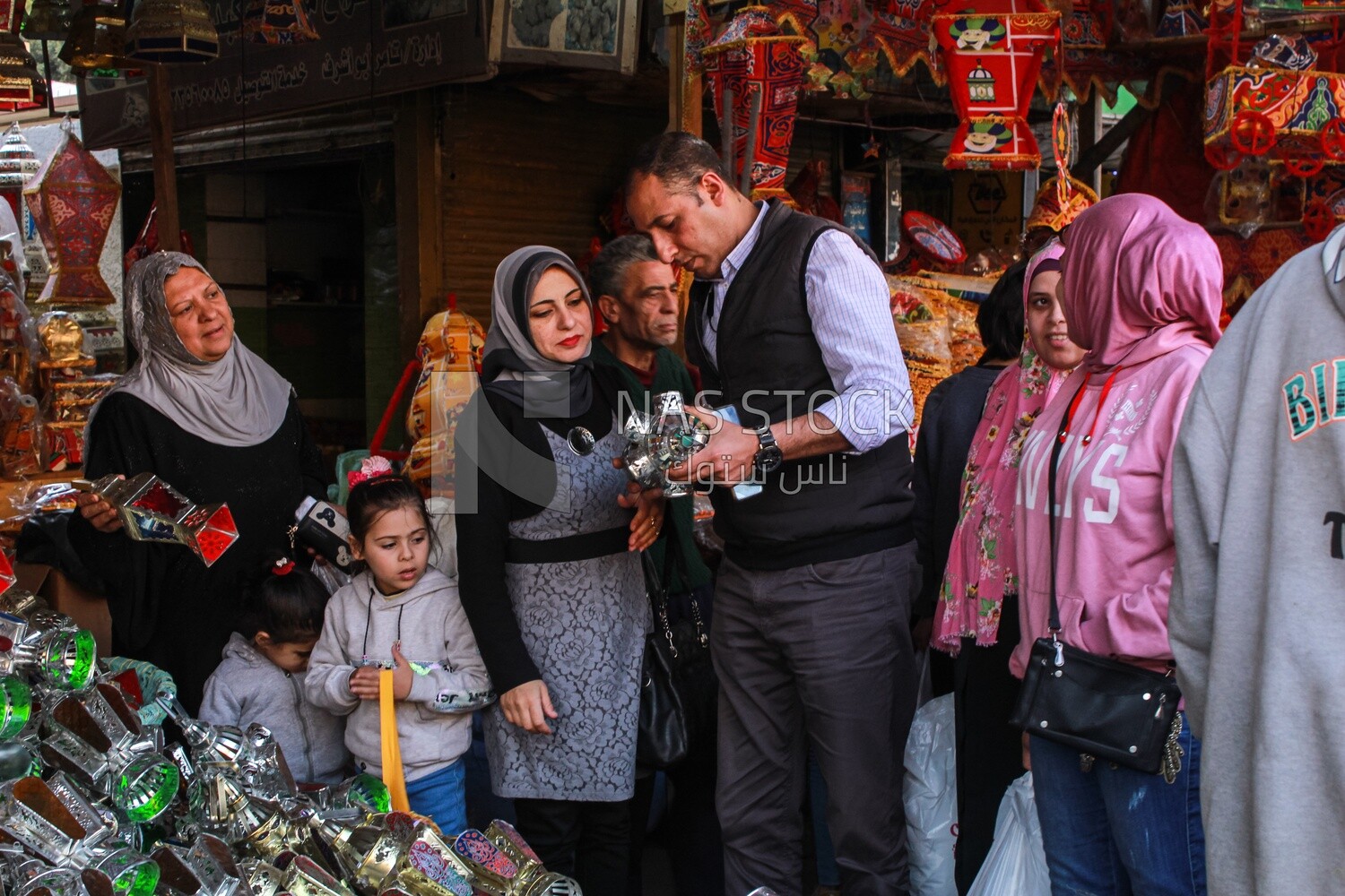 man and his wife buy lanterns from an Egyptian store