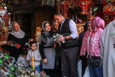 man and his wife buy lanterns from an Egyptian store