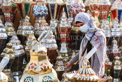 woman buys a lantern to celebrate Ramadan