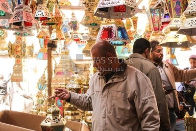 man buys a lantern to celebrate Ramadan