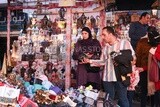 man and his wife buy lanterns from an Egyptian store