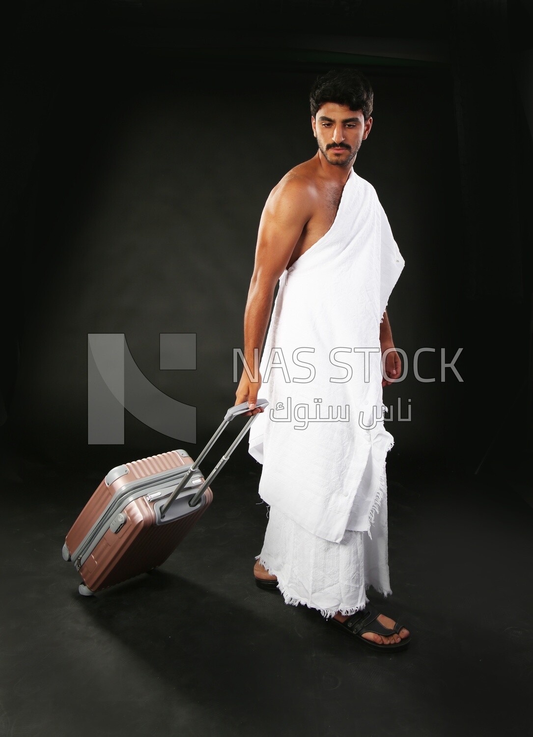 A man wearing an ihram dress with his luggage