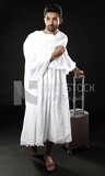 A man wearing an ihram dress with his luggage