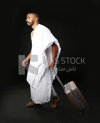 A man wearing an ihram dress with his luggage