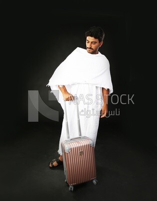 A man wearing an ihram dress with his luggage