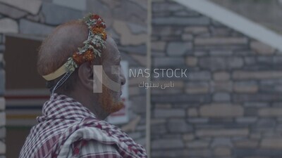 رجل سعودى يرتدى اكليل من الورد العسيري ,  الزي الشعبي الجنوبي , قرية رجال ألمع , عسير ,  السعودية