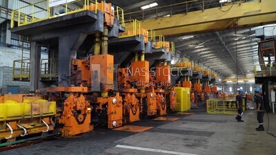 Scene inside a steel factory, iron making machines, steel making workers