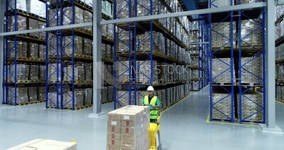 a man riding an order picker inside a store