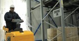 Man riding an order picker inside a store