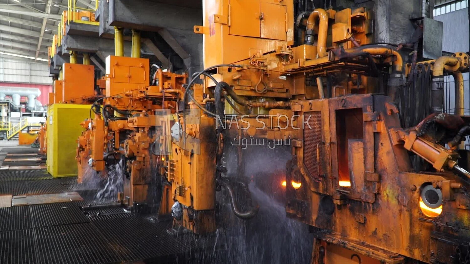 Scene inside a steel factory, iron making machines, steel making workers