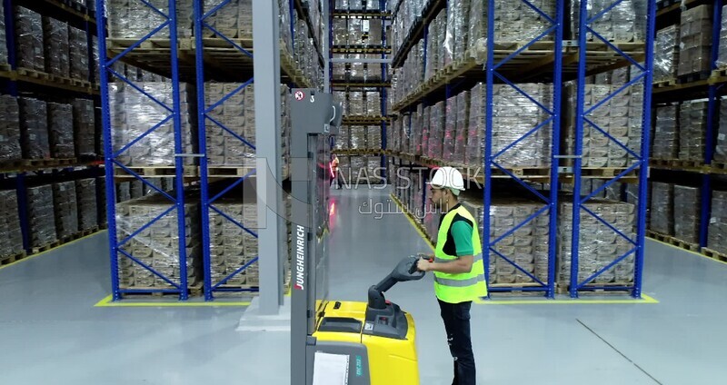 Man riding an order picker inside a store