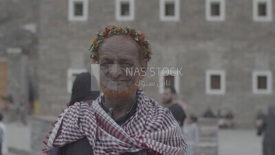 Saudi man wearing a wreath of Asiri roses, southern folk costume, Rijal Almaa village, Asir, Saudi Arabia