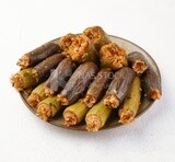 Side view of  A dish made of stuffed zucchini, stuffed peppers and stuffed eggplant  on a white background