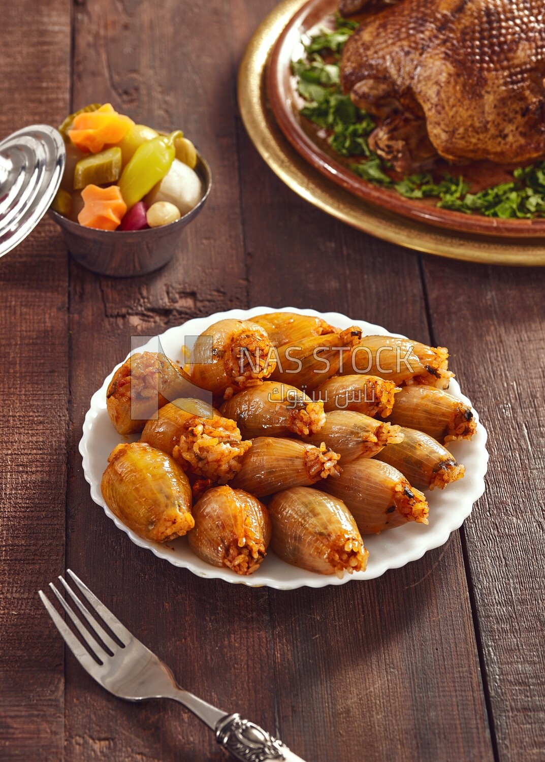 Side view of a scene from a Dining table with Stuffed onions and roast duck