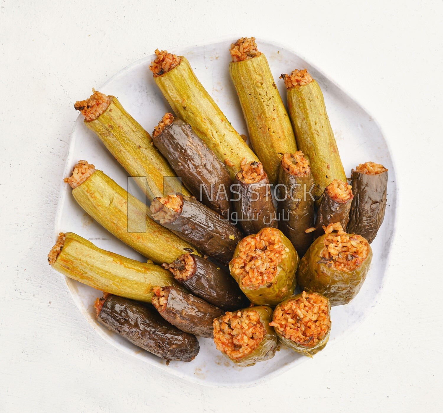 Top view of a dish made of stuffed zucchini, stuffed peppers and stuffed eggplant