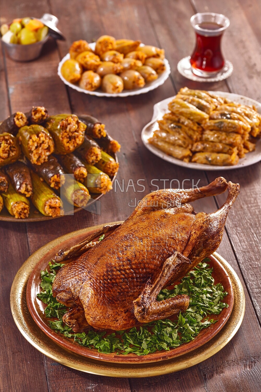 Side view of a scene from a Ramadan lunch table with roast duck and  different types of stuffed vegetables