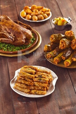 Top view of a Ramadan lunch table with roast duck and  different types of stuffed vegetables