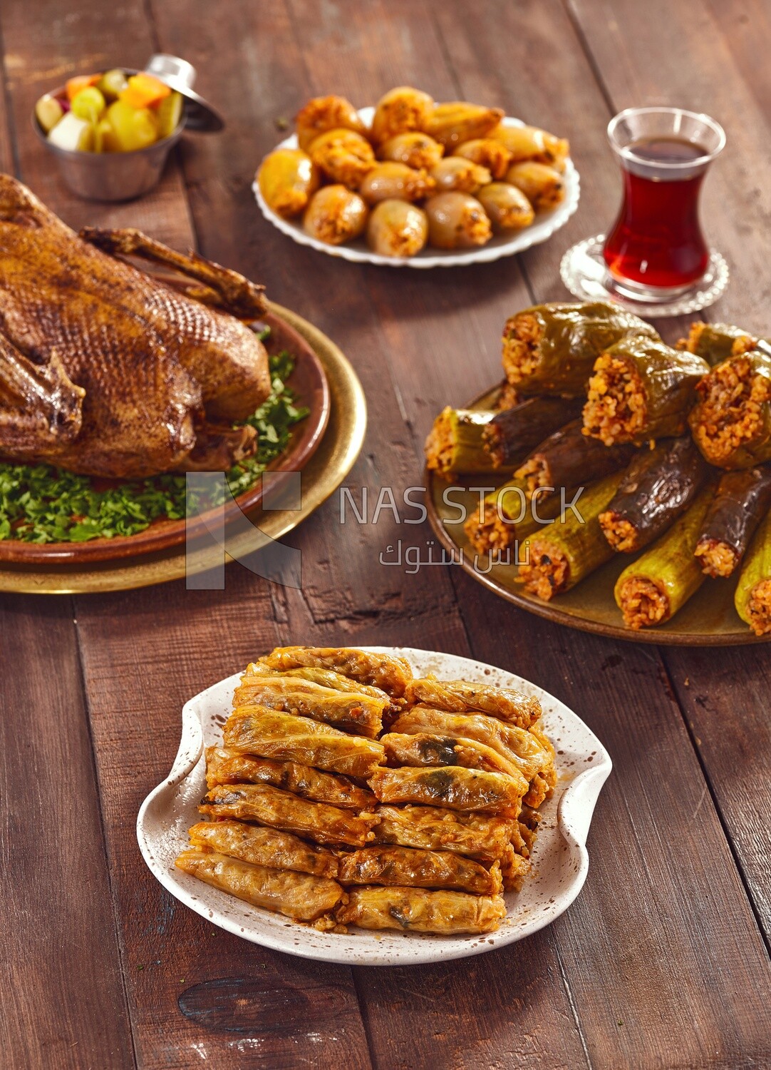 Side view of a scene from a Ramadan lunch table with roast duck and  different types of stuffed vegetables