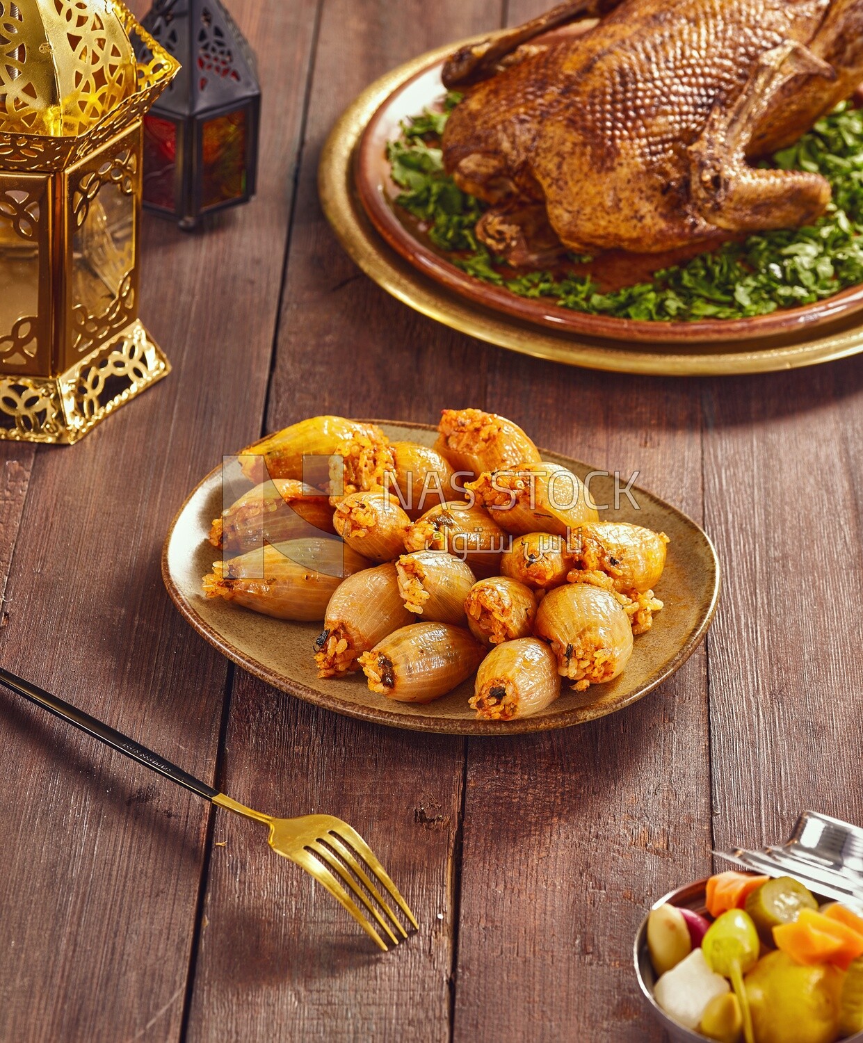 Side view of a scene from a Dining table with Stuffed onions and roast duck