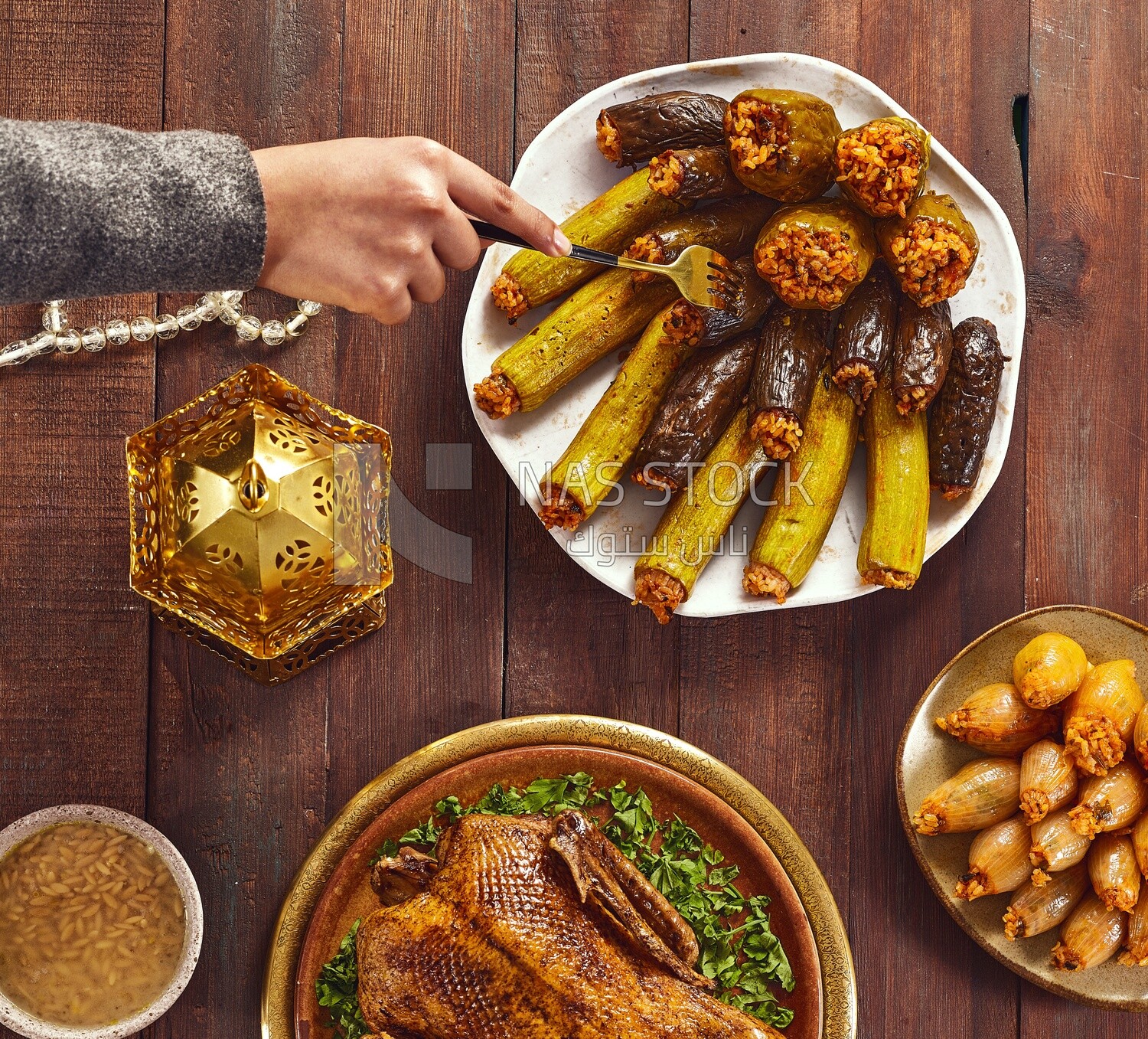 Top view of a person eating stuffed eggplant from the Ramadan table