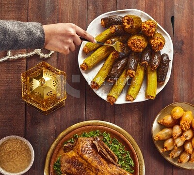 Top view of a person eating stuffed eggplant from the Ramadan table