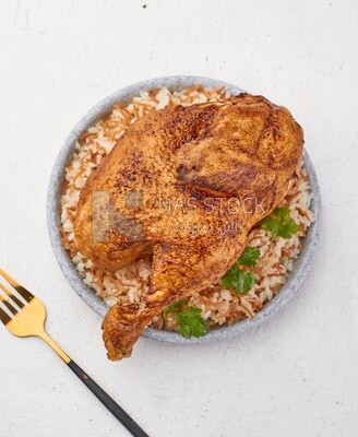 Top view of a plate of rice with chicken on a white background