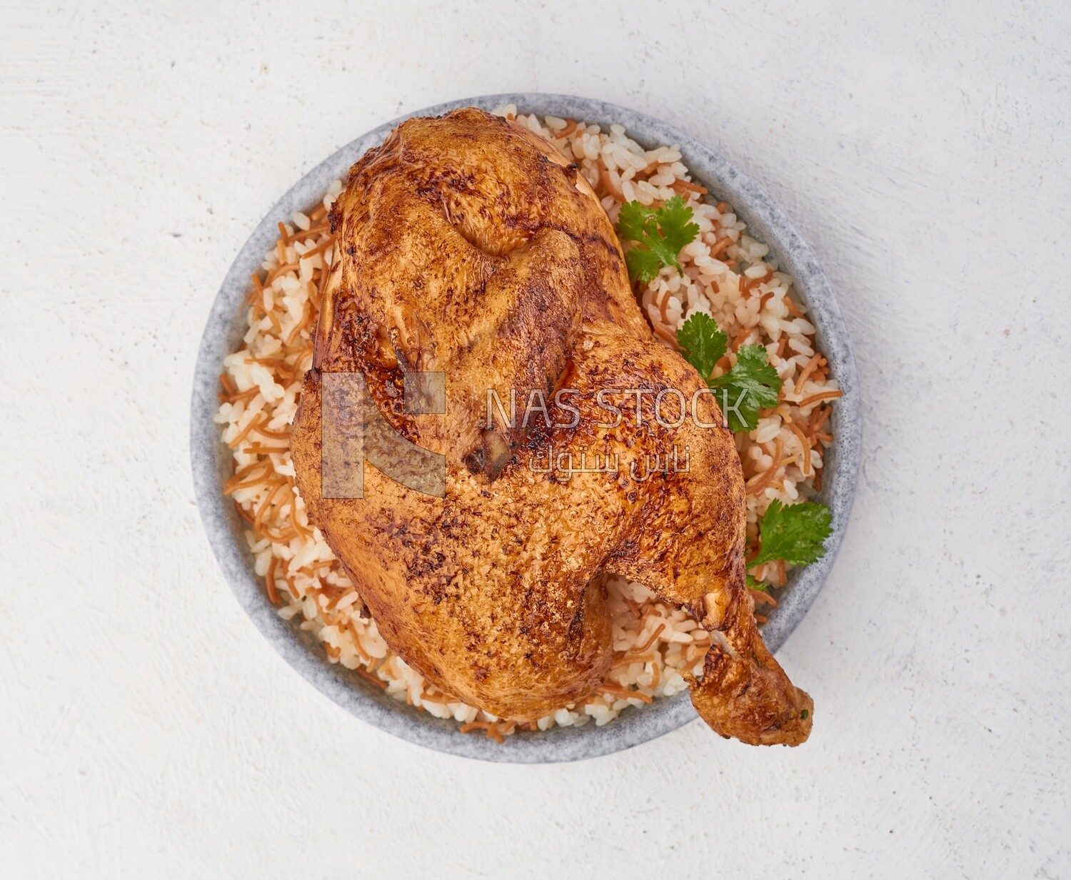 Top view of a plate of rice with chicken on a white background