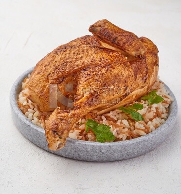 Side view of a plate of rice with chicken on a white background
