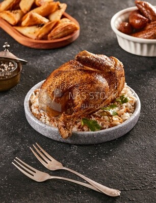 Side view of a dining table with chicken rice, samosa and mombar
