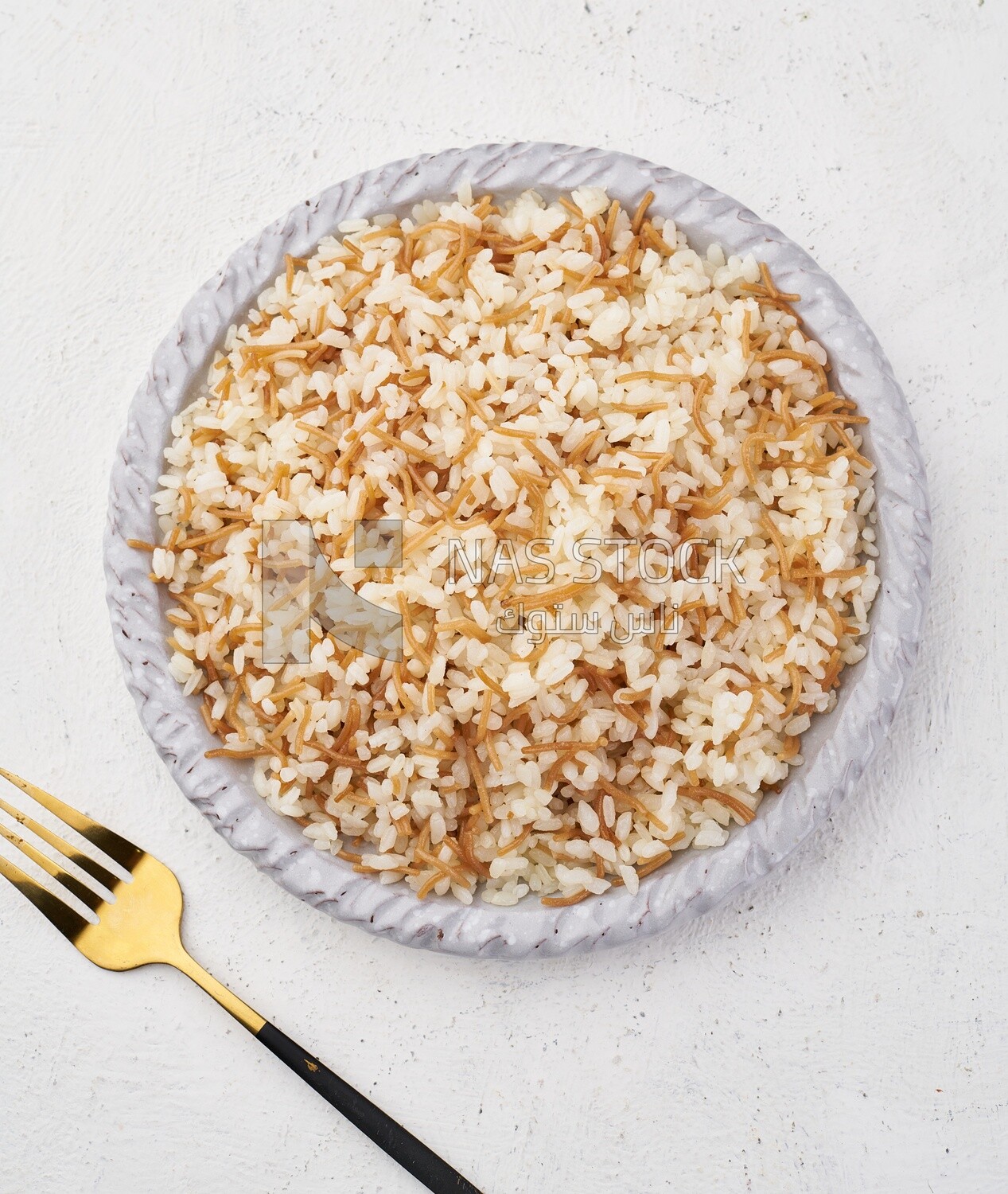 Top view of a plate of Classic Egyptian Rice with Vermicelli  on a white background