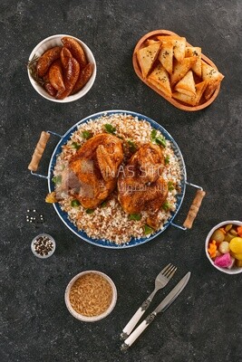 Side view of a dining table with chicken rice, samosa, soup and mombar