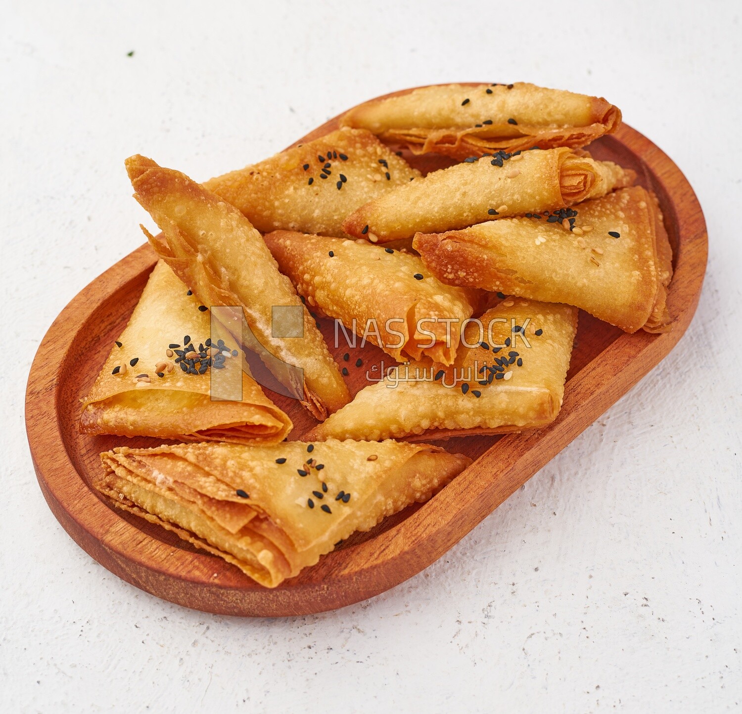 Side view of a plate of Samosa on a white background