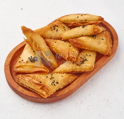 Side view of a plate of Samosa on a white background