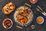 Top view of a Ramadan dining table with chicken rice, samosa, mombar  and soup