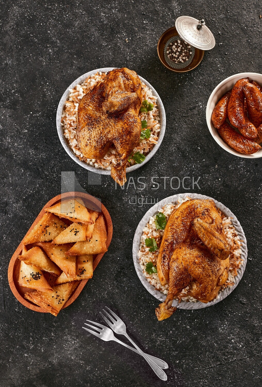 Top view of a dining table with chicken rice, samosa and mombar